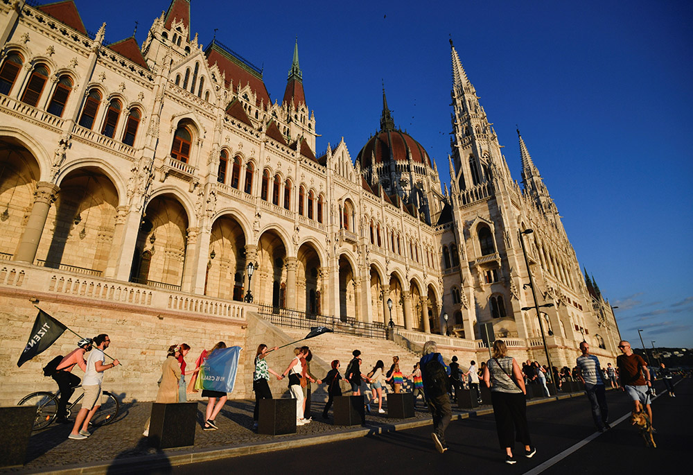 Demonstrators march around the Hungarian parliament as they protest against Hungarian Prime Minister Viktor Orbán and a new law forbidding the promotion of homosexuality or gender change for minors, June 14, 2021, in Budapest. (CNS/Reuters/Marton Monus)