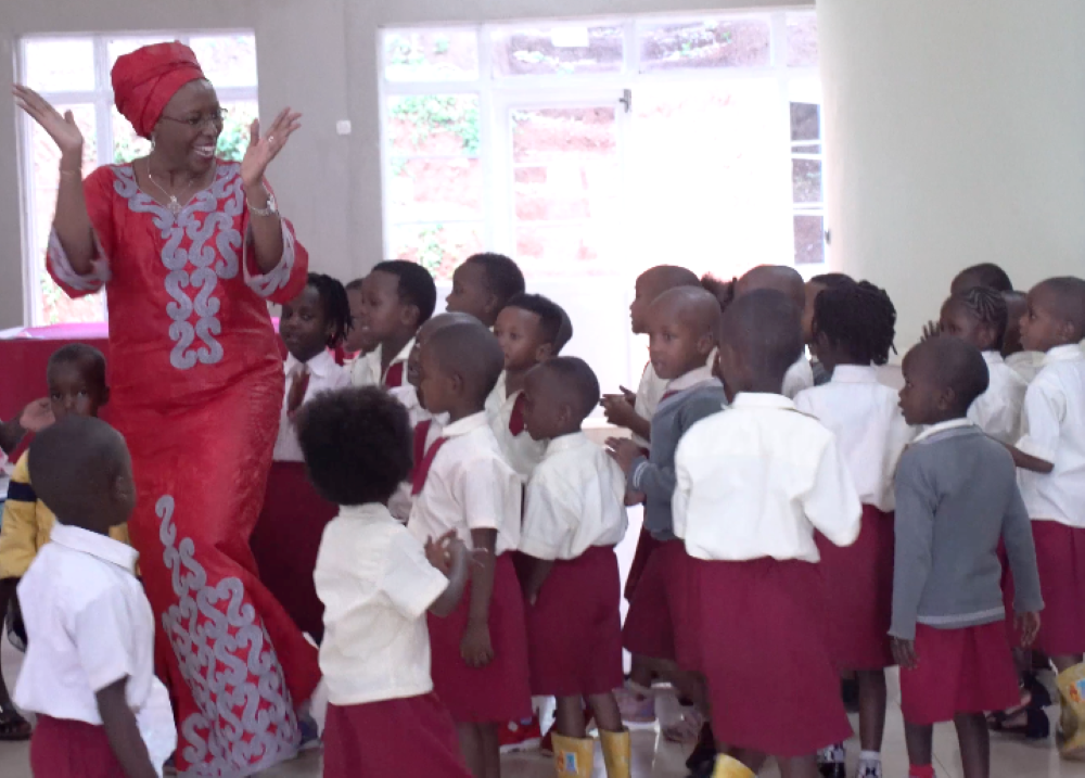 Maggy Barankitse dances with children at her humanitarian organization in Burundi.