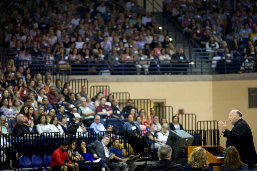 Bishop McElroy speaks to large crowd of people. 