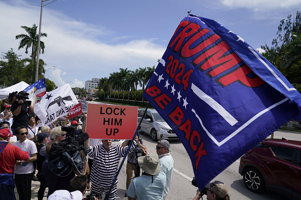 Protesters and supporters of former President Donald Trump wait for him to arrive at Trump National Doral golf resort on June 12 in Doral, Florida. (AP/Evan Vucci)