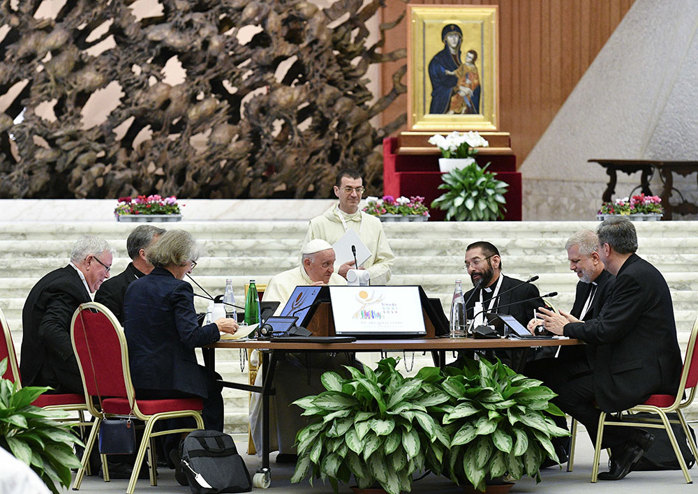 Bishop Daniel Flores of Brownsville, Texas, sits next to Pope Francis during the assembly of the Synod of Bishops Oct. 10 in the Paul VI Audience Hall at the Vatican. (CNS/Vatican Media)