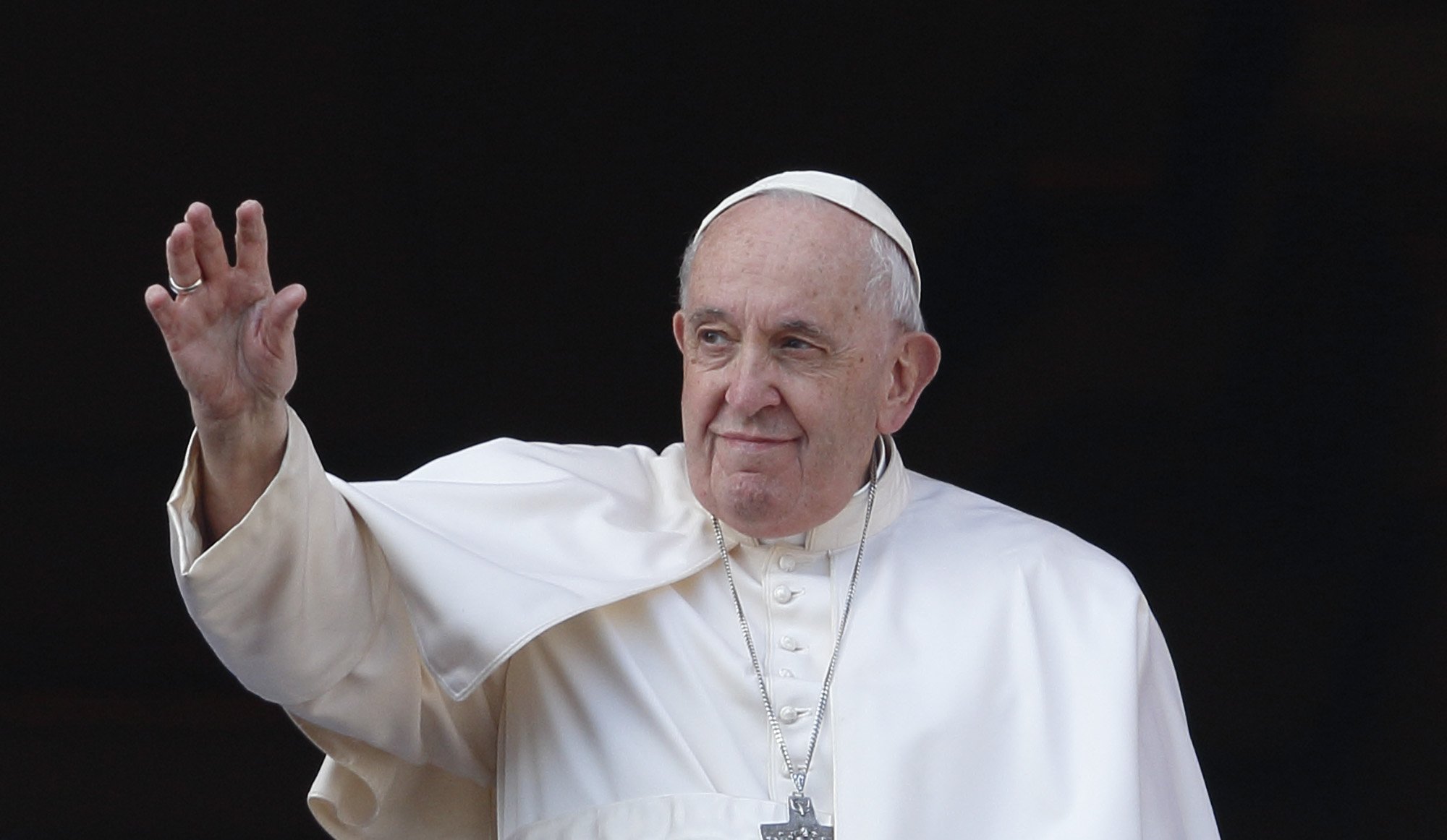 Pope Francis greets the crowd as he leads his Christmas message and his blessing "urbi et orbi" (to the city and the world) from the central balcony of St. Peter's Basilica at the Vatican Dec. 25, 2022. (CNS photo/Paul Haring)