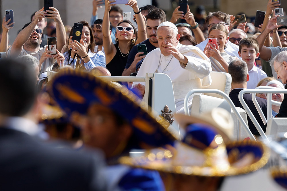 Pope Francis greets visitors as he rides the popemobile around St. Peter's Square before his weekly general audience at the Vatican May 29, 2024. (CNS/Lola Gomez)