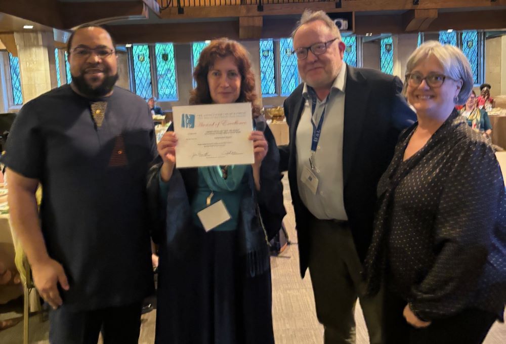 GSR editor Gail DeGeorge, second from left, and international correspondent Chris Herlinger, appear with Associated Church Press President John Thomas III, far left, and Vice President Sally Hicks, far right, during an May 17 awards ceremony.