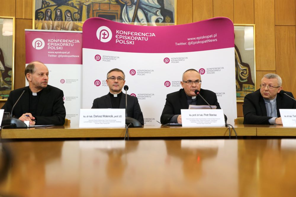 Fr. Leszek Gesiak, spokesman of the Polish bishops' conference, left, is seen at a Jan. 9 press conference in Warsaw.