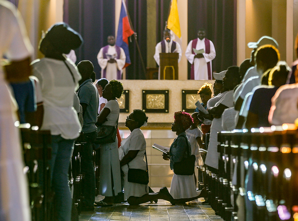 Faithful kneel in prayer during a Good Friday service at the St. Pierre Catholic Church in the Pétion-Ville neighborhood of Port-au-Prince, Haiti, on March 29. (AP/Odelyn Joseph)