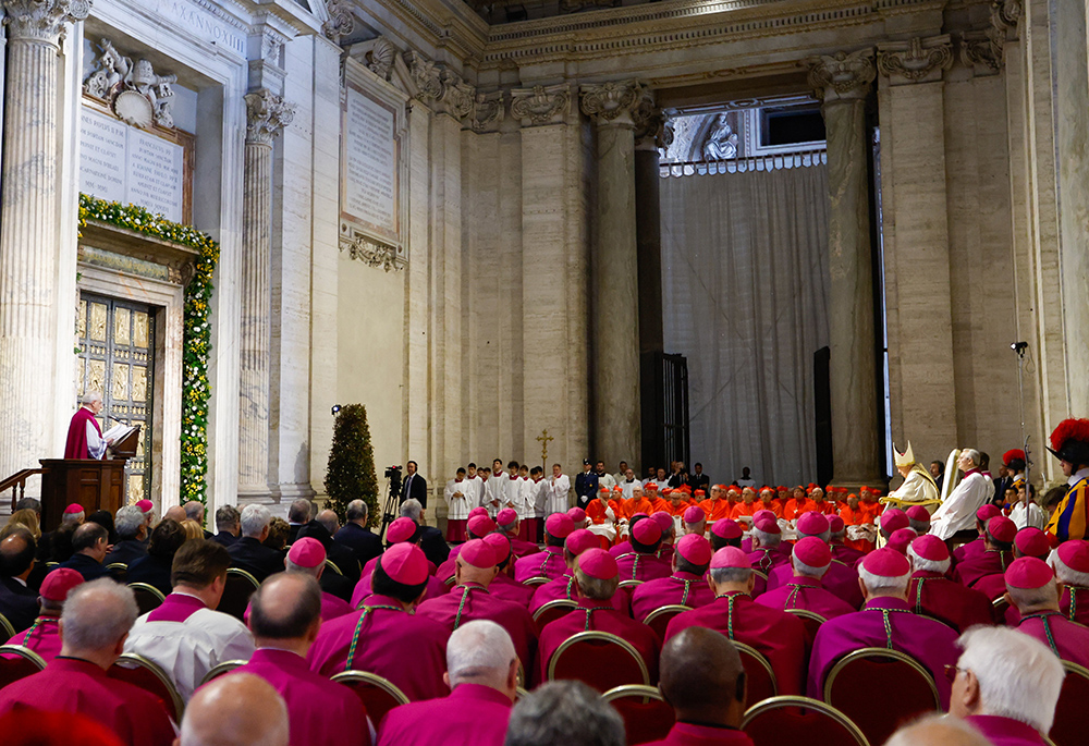 Pope Francis, members of the Roman Curia and other church officials listen as Msgr. Leonardo Sapienza reads excerpts of Spes Non Confundit, ("Hope Does Not Disappoint"), his document proclaiming the Holy Year 2025, during a ceremony in front of the Holy Door of St. Peter's Basilica May 9 at the Vatican. (CNS/Lola Gomez)