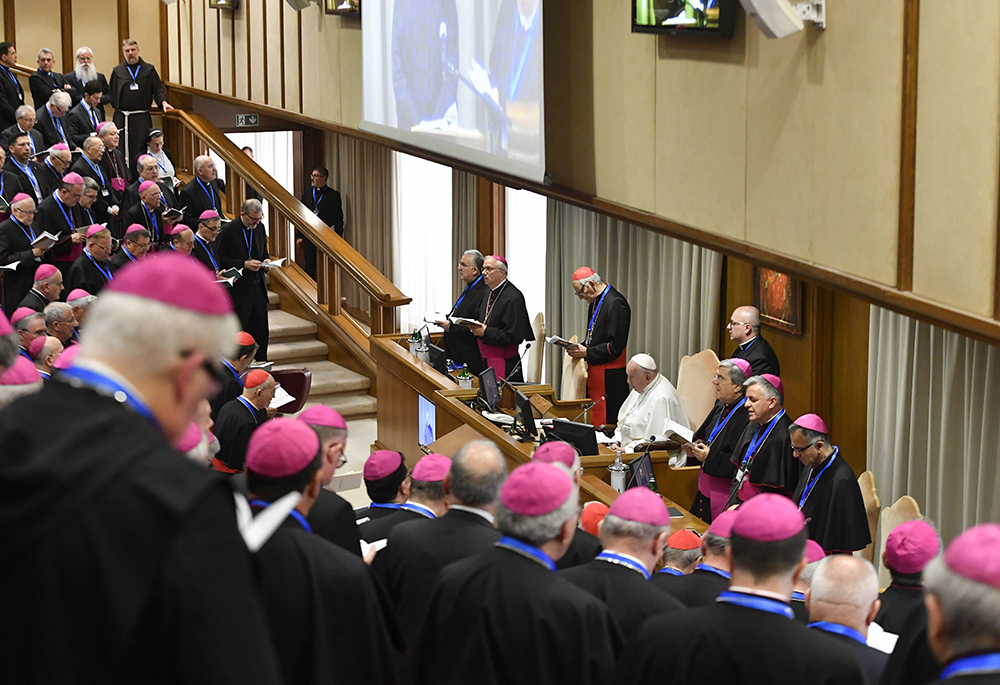 Pope Francis prays with Italian bishops in the Vatican synod hall during the general assembly of the Italian bishops' conference on May 20. (CNS/Vatican Media)