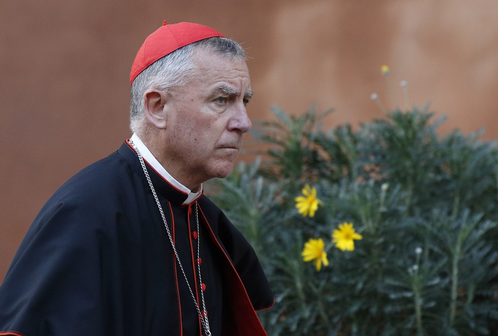 Dew pictured outdoors in Cardinal's clerical garb. 