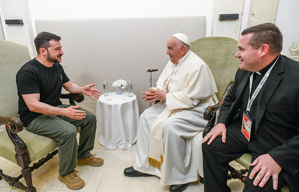 Pope Francis and Ukrainian President Volodymyr Zelenskyy, with a priest serving as interpreter, meet privately on the margins of the G7 summit in Borgo Egnazia, Italy, June 14. (CNS/Vatican Media)