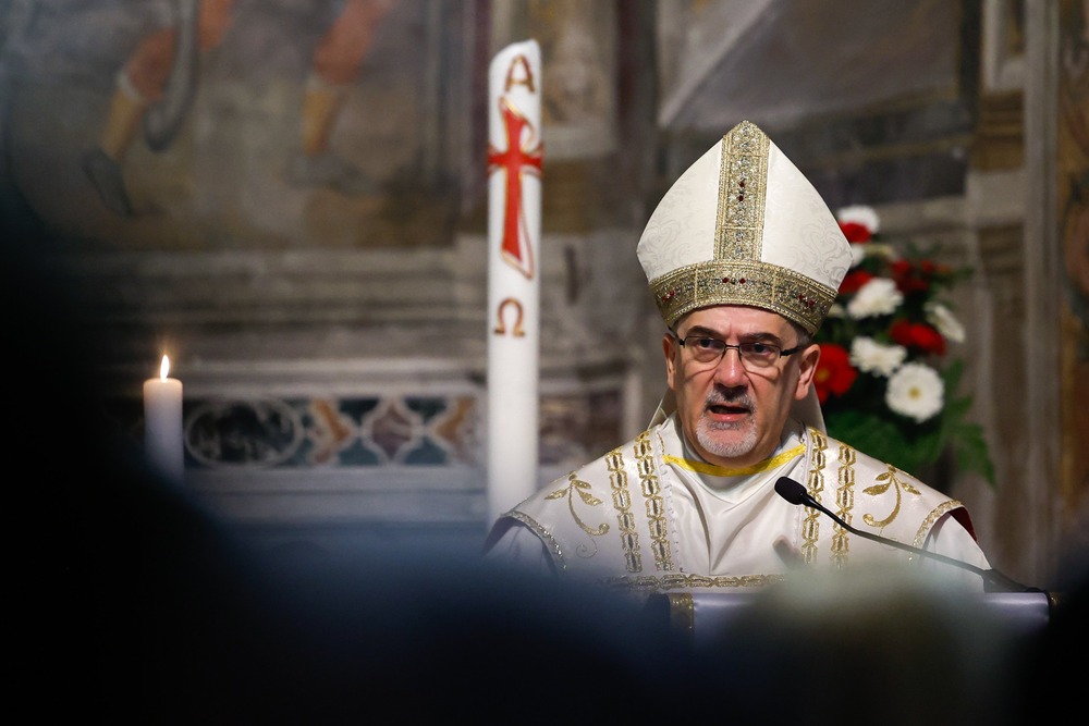 Cardinal Pizzaballa, vested, preaches at lectern