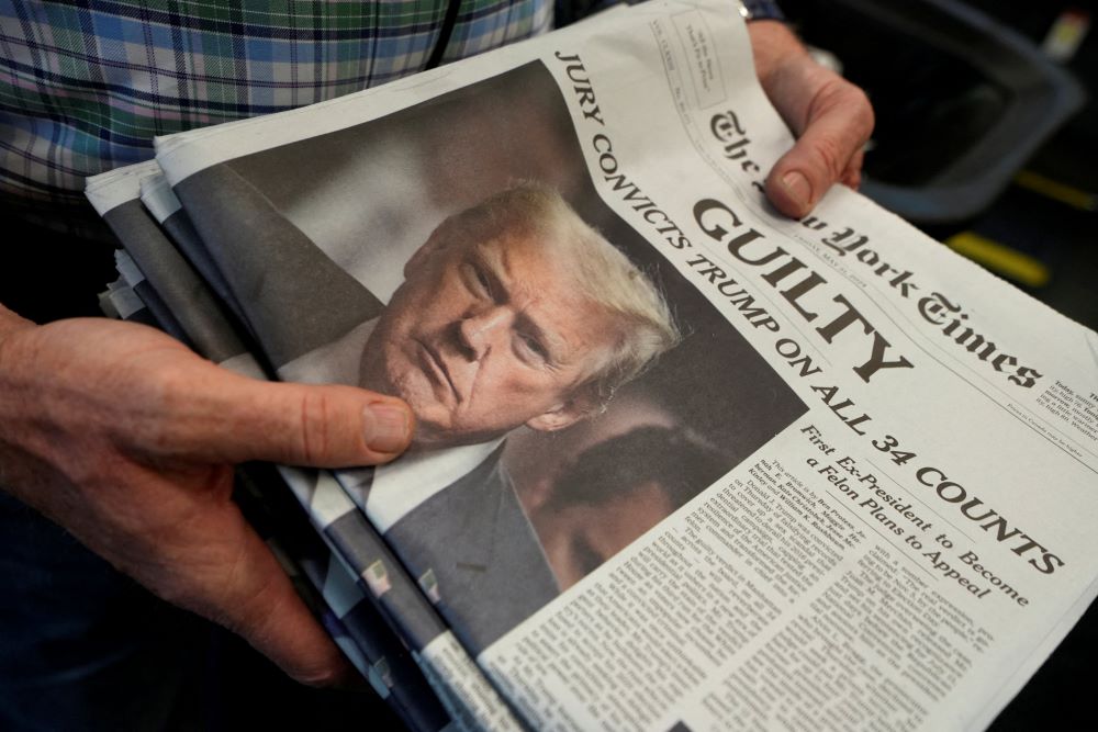 A person holds New York Times newspapers at the printing plant in New York City May 30, following the announcement of the guilty verdict on former U.S. President Donald Trump's criminal triall.