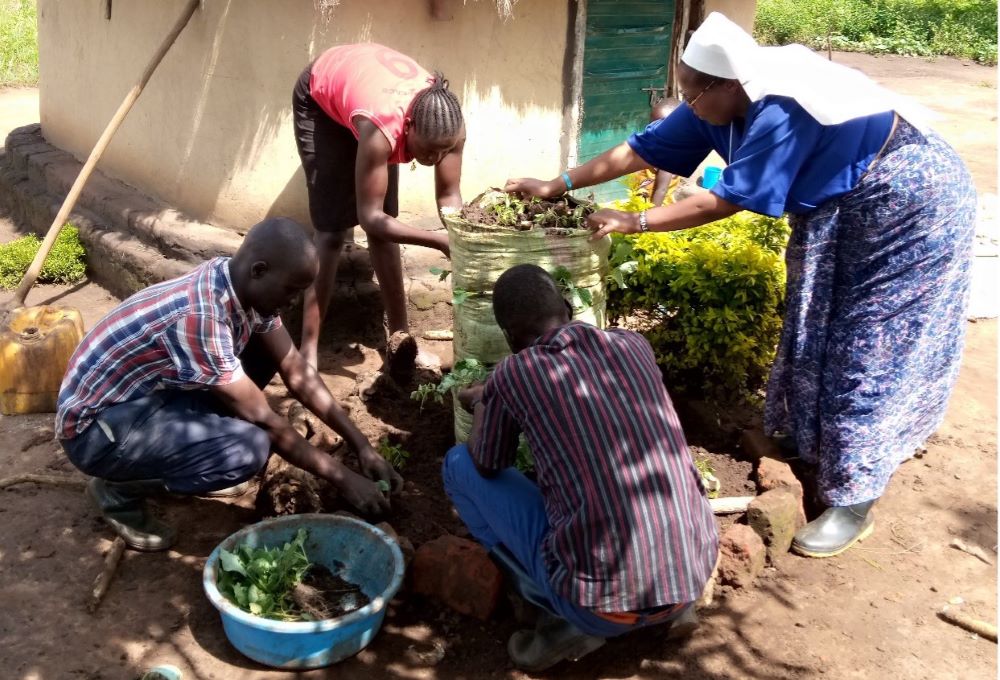 Sr. Zipporah Ngoiri Waitathu, right, demonstrates how to make a garden in a sack.