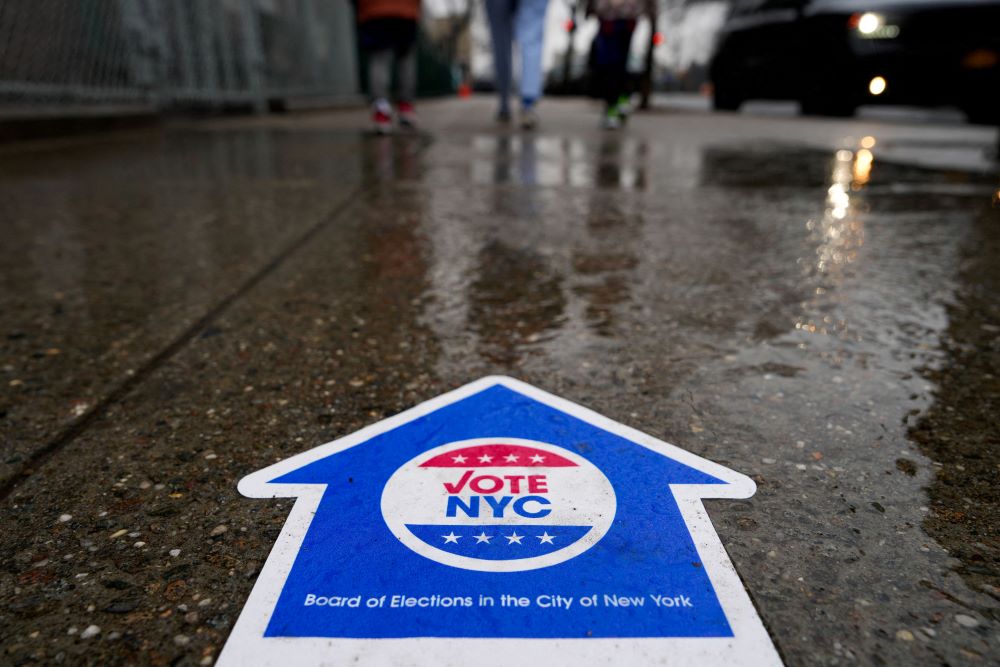 A sign directing people to vote in the New York Presidential Primary election is seen on the pavement in New York City April 2 (OSV News/Reuters/Adam Gray)