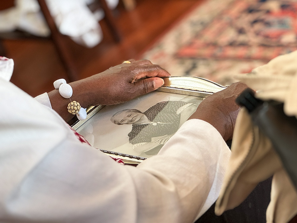 Laurice Redhead holds a photo of her grandmother during Mass at the Chapel of St. Ignatius at Holy Trinity Catholic Church in Washington June 19, when current parishioners gathered with descendants of former Black parishioners who left the church in the 1920s because of segregation. (NCR photo/Rhina Guidos)