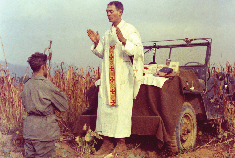 U.S. Army chaplain Fr. Emil Joseph Kapaun, who died May 23, 1951, in a North Korean prisoner of war camp, is pictured celebrating Mass from the hood of a jeep Oct. 7, 1950, in South Korea. (CNS/Courtesy U.S. Army medic Raymond Skeehan)