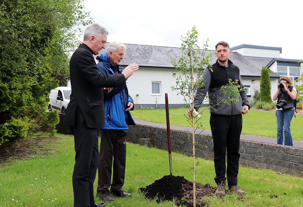 Jesuit Fr. Brian Grogan participates in a tree planting at the Creation Walk at Knock Shrine. Also pictured is Fr. Richard Gibbons, rector of Knock Shrine, and horticulturalist Dylan Prendergast. (Sinead Mallee)