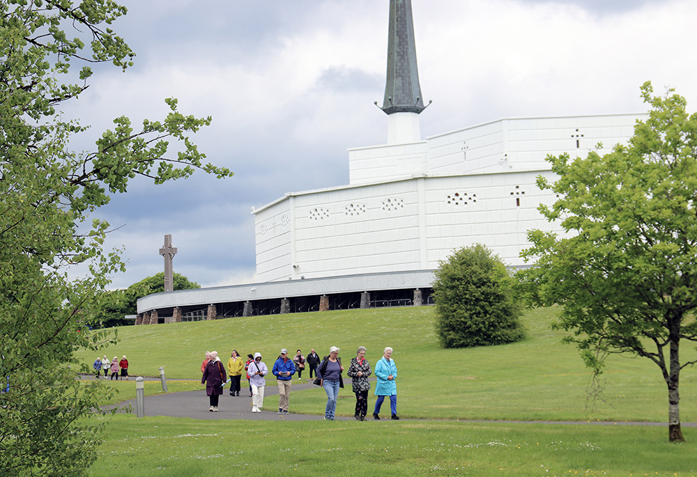 Visitors to Knock Shrine walk through the grounds. (Sinead Mallee)
