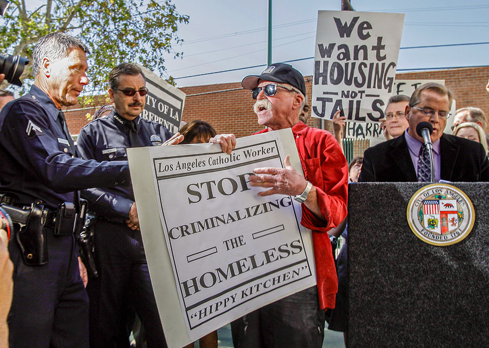 Catholic Worker Jeff Dietrich, center, protests in Los Angeles in 2010. (AP/Reed Saxon)