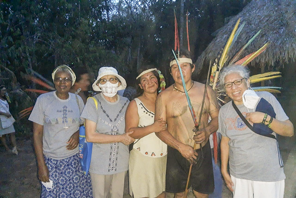 Sr. Zully Rojas Quispe, right, together with other Catholic sisters and two Indigenous people belonging to the Harakbut culture during one of the initiation rites of the ethnic group (Courtesy of Zully Rojas Quispe)