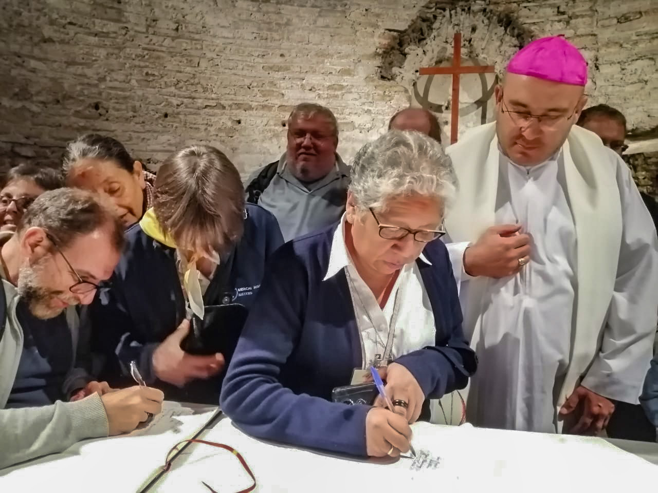 Dominican Sr. Zully Rojas Quispe at the Catacombs of Domitilla in Rome, signs the "Pact of the Catacombs for the Common Home" along with some of the participants of the synod for the Amazon held in October 2019. (Courtesy of Zully Rojas Quispe)