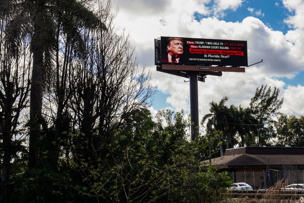 A billboard sponsored by the the Democratic National Committee as seen in February in Miami. The group sponsored 40 billboards across seven battleground states calling out the IVF ruling in Alabama. (Grist/Getty Images for DNC/John Parra)