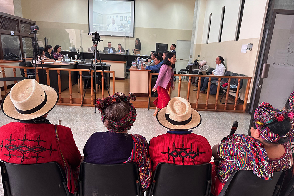 Maya Ixil people attend the hearing against retired Gen. Benedicto Lucas García, on the screen, at a court in Guatemala City. A Guatemalan court began a trial against Lucas, 91, already convicted of crimes against humanity, for the massacre of more than 1,200 Indigenous Ixil Maya people between 1978 and 1982. (Mary Jo McConahay)