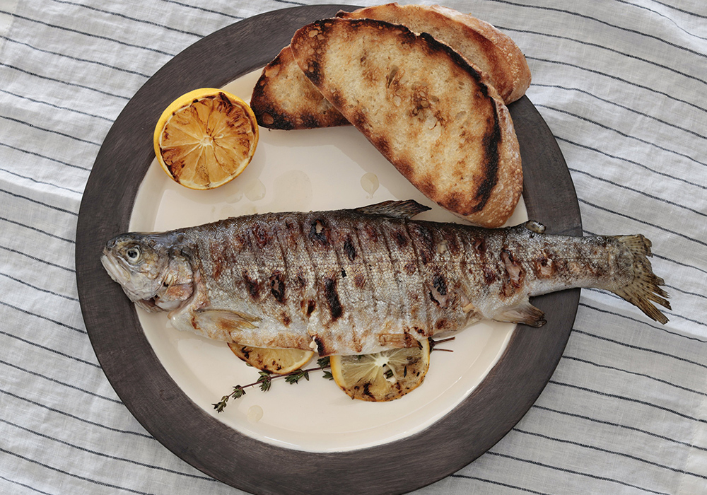 Grilled rainbow trout is accompanied by toasted bread. (CNS/Nancy Wiechec)