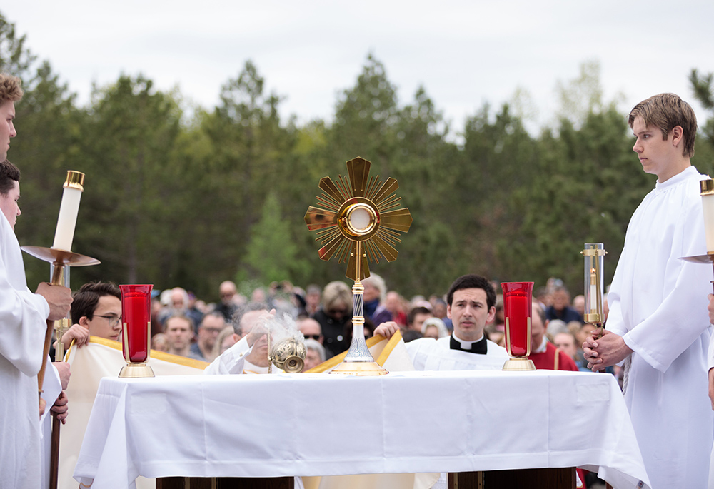 The Eucharist is displayed for pilgrims' veneration by Bishop Andrew Cozzens of Crookston, Minnesota, along the procession to the headwaters of the Mississippi River May 19 for the launch of the Marian Route of the National Eucharistic Pilgrimage. (OSV News/Courtney Meyer)