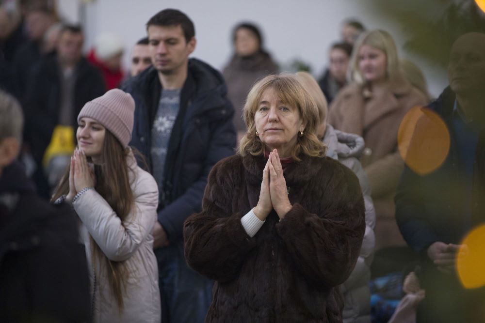 Worshippers pray the blessing of water on the Dnipro River after Major Archbishop Sviatoslav Shevchuk, head of the Ukrainian Greek Catholic Church, celebrated a Divine Liturgy Jan. 6 at the Patriarchal Cathedral of the Resurrection of Christ in Kyiv.