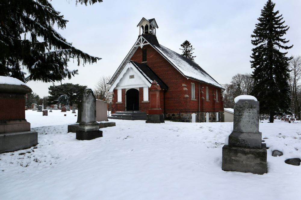 Gravestones stand near church.