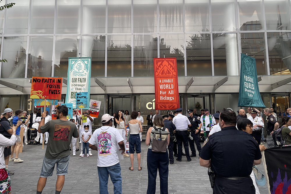 Interfaith environmental protestors blocked the entrance doors of Citigroup’s headquarters in downtown New York on July 30. (NCR photo/Camillo Barone)