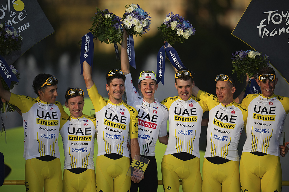 Tour de France winner's Tadej Pogačar, center, and his UAE Team Emirates were awarded the best team after the 21st stage of the Tour de France cycling race, an individual time trial over 33.7 kilometers (20.9 miles) with start in Monaco and finish in Nice, France, July 21, 2024. (AP/Daniel Cole)