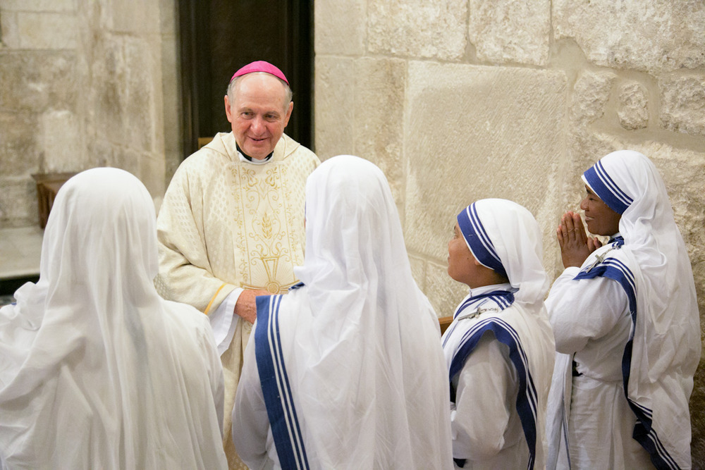 Bishop Pates, vested, smiles at Sisters.