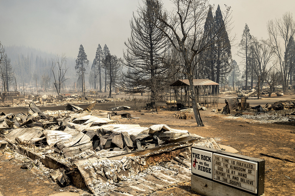 Marquee stands next to burnt ruins and scorched ground.