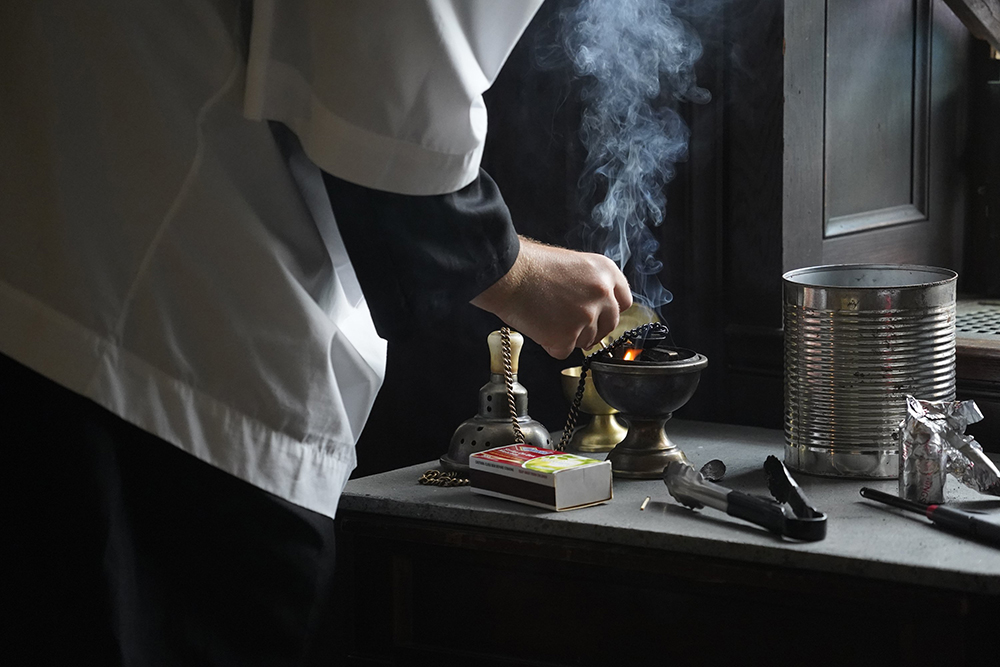 Altar server Bradley Morley prepares a censer for use during a traditional Latin Mass July 1, 2021, at Immaculate Conception Seminary in Huntington, New York. (CNS/Gregory A. Shemitz)