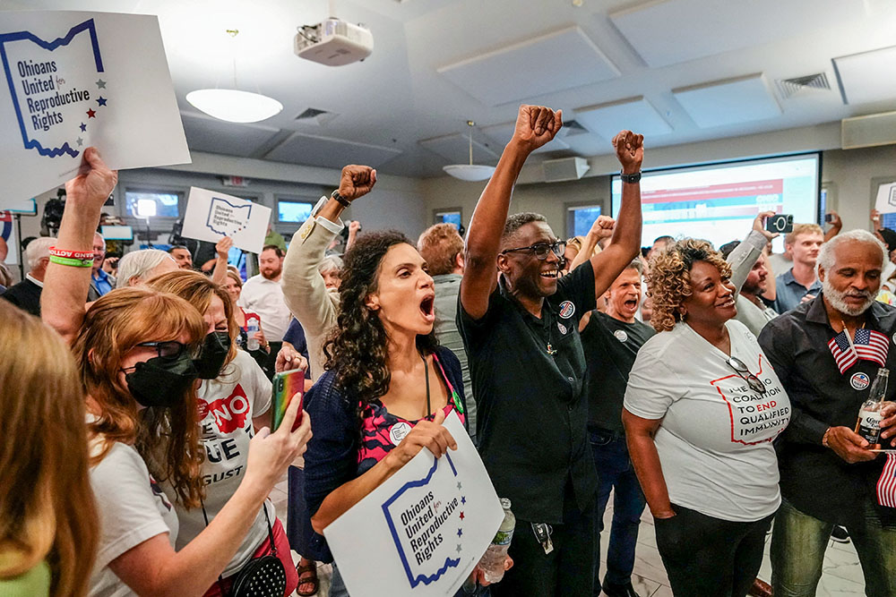 People celebrate the defeat of Issue 1, a Republican-backed measure that would have made it harder to amend the state constitution, an initiative aimed at helping defeat a November referendum that would protect abortion access in the state, after early results were announced during an election night party at the Columbus Fire Fighters Local 67 in Columbus, Ohio, U.S. August 8, 2023. (OSV News/USA Today Network via Reuters/Adam Cairns)