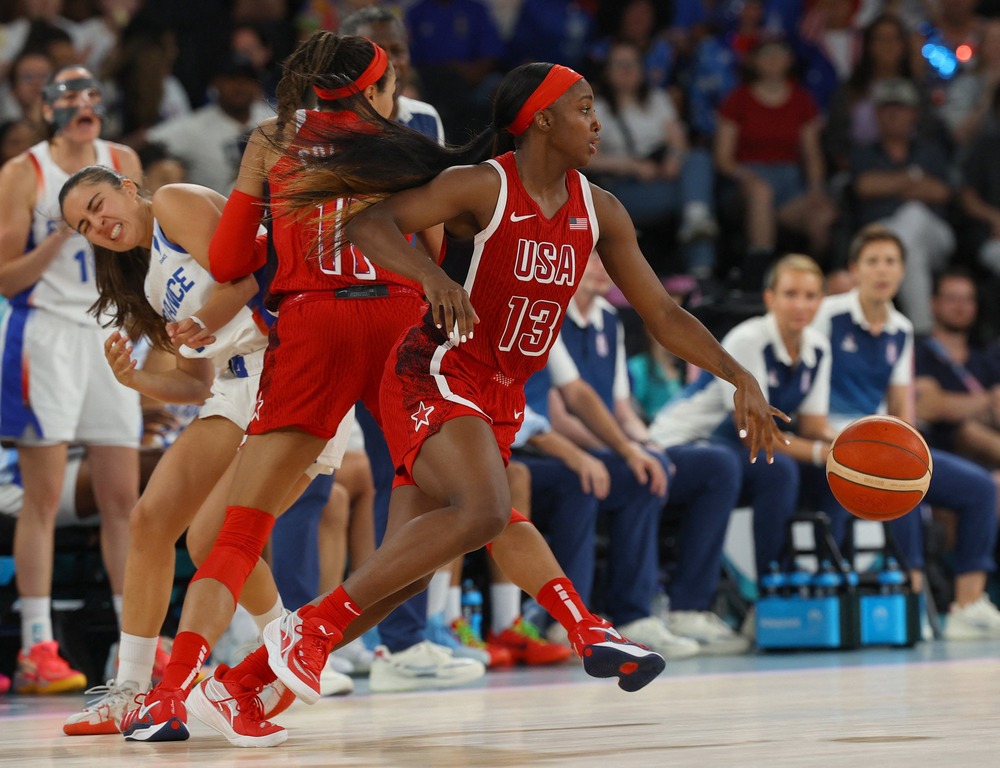 Dynamic live photo of game play depicting Jackie Young bounding across court. 