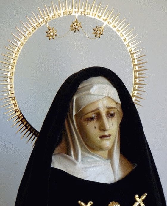 Upper portion of black-mantled, and haloed Virgin of Sorrows. 