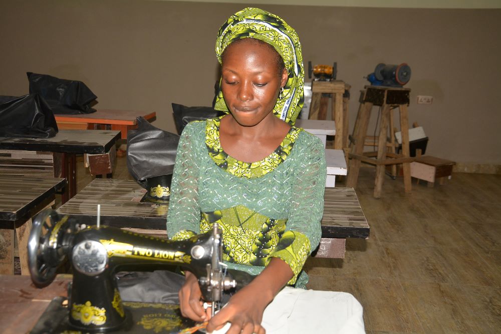 Janada Markus works on a clothing project at the skill acquisition department of the Salama Centre in Maiduguri, Nigeria.