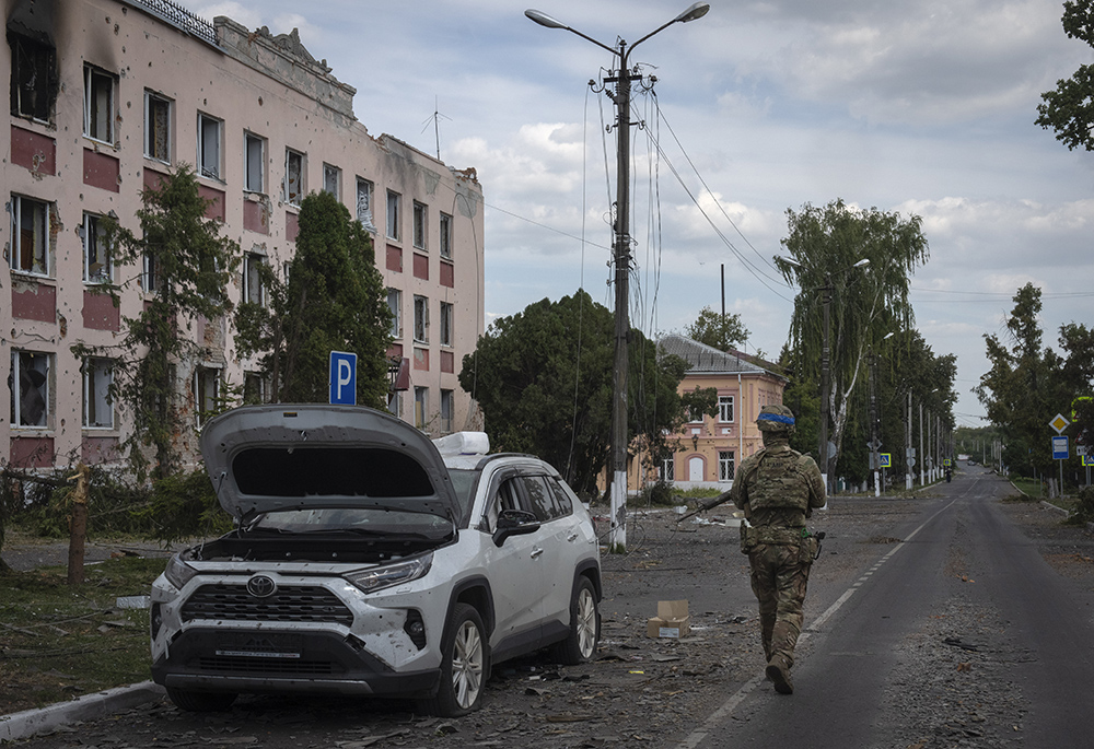 A Ukrainian soldier walks past at a city hall in Sudzha, Kursk region, Russia, on Aug. 16, 2024. The Associated Press noted that this image was approved by the Ukrainian Defense Ministry before publication. (AP photo)