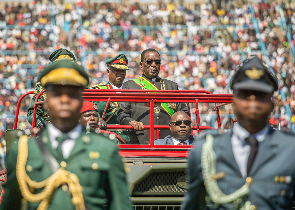 Zimbabwean President Emmerson Mnangagwa, center, inspects an honor guard from a military truck during Zimbabwe Defence Forces Day commemorations at Rufaro Stadium in Harare Aug. 13. (AP/Aaron Ufumeli)