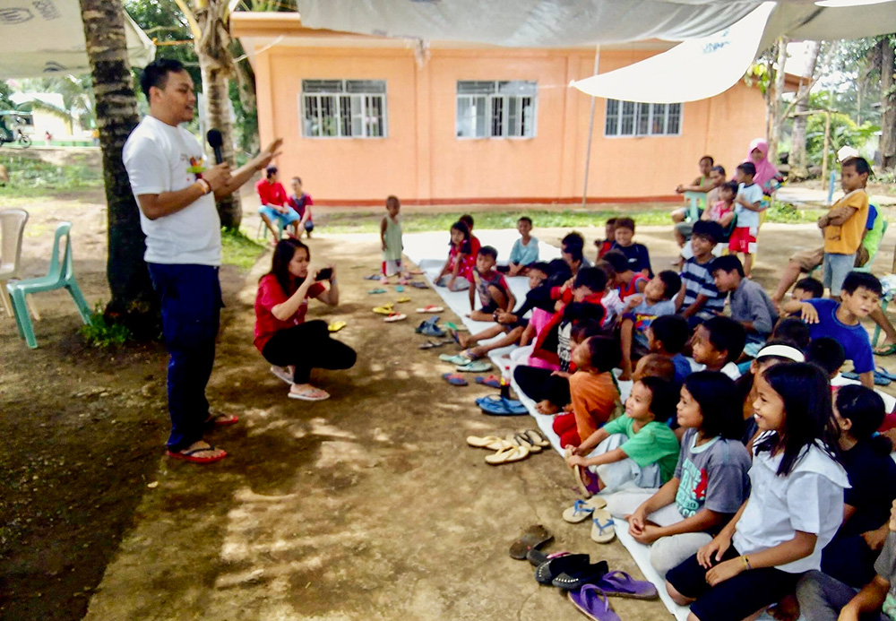 Franciscan Br. Christopher Villanueva at an evacuation site with children displaced by the Siege of Marawi in the Philippines (Courtesy of Order of Friars Minor)