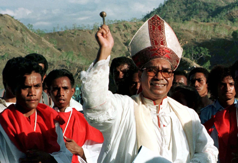 East Timorese Bishop Carlos Ximenes Belo sprinkles holy water during an outdoor Mass in Dili in this file photo. The bishop, now retired, has been accused of sexual abuse of minors. (CNS/Reuters)