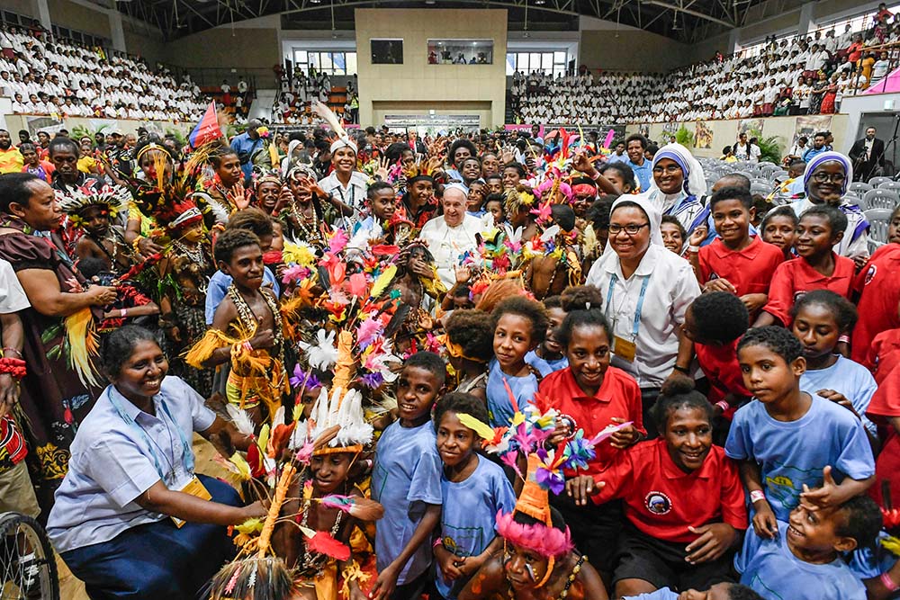 Pope Francis poses for a photo with children at the Caritas Technical Secondary School in Port Moresby, Papua New Guinea, Sept. 7. (CNS/Vatican Media)