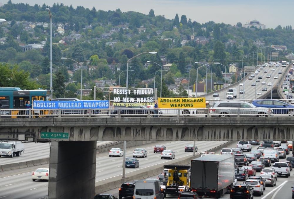 Banners draped over an Interstate 5 overpass in Seattle call attention to the nearby arsenal of nuclear weapons. 