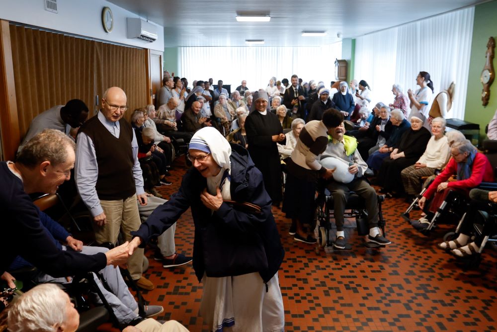 Residents and staff at St. Joseph's Home in Brussels greet the pope.