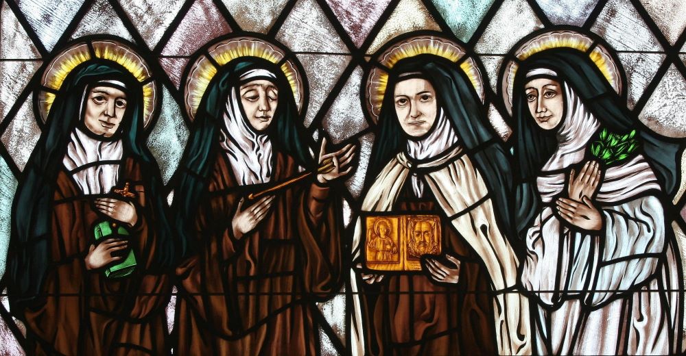 Stained glass depicts Sts. Teresa Benedicta of the Cross, Theresa of Avila, Thérèse of Lisieux and Catherine of Siena. 