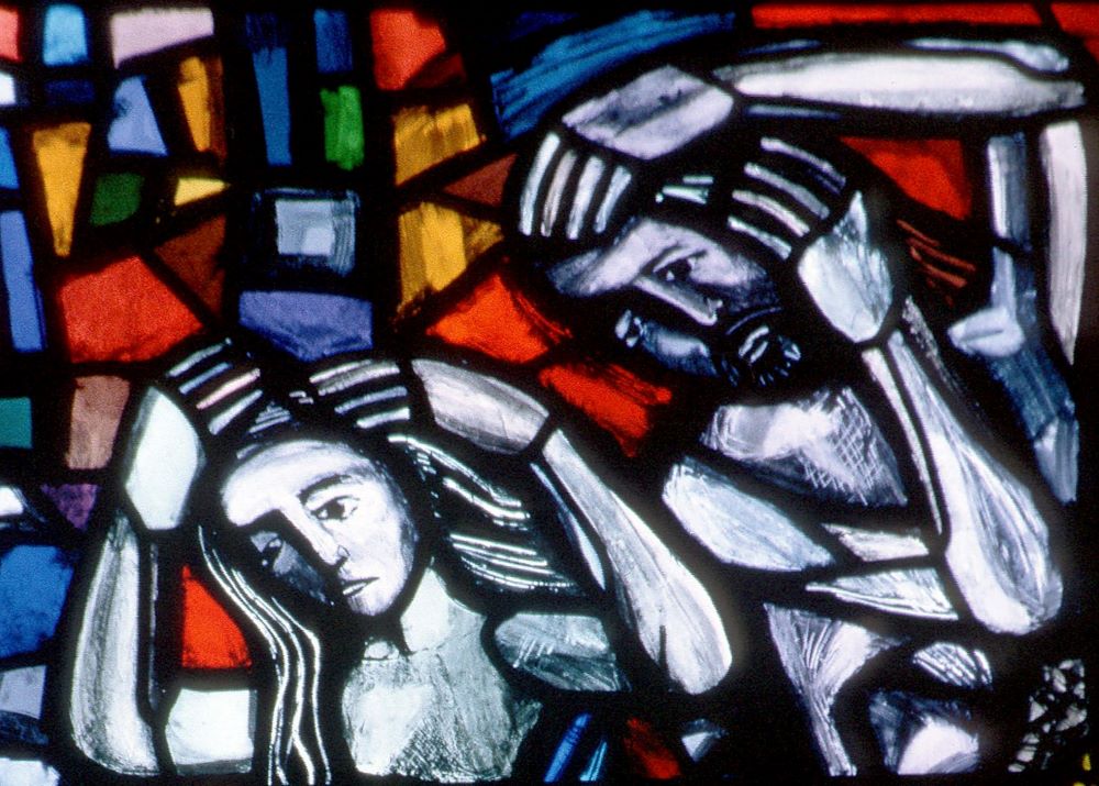 Adam and Eve depicted in stained glass