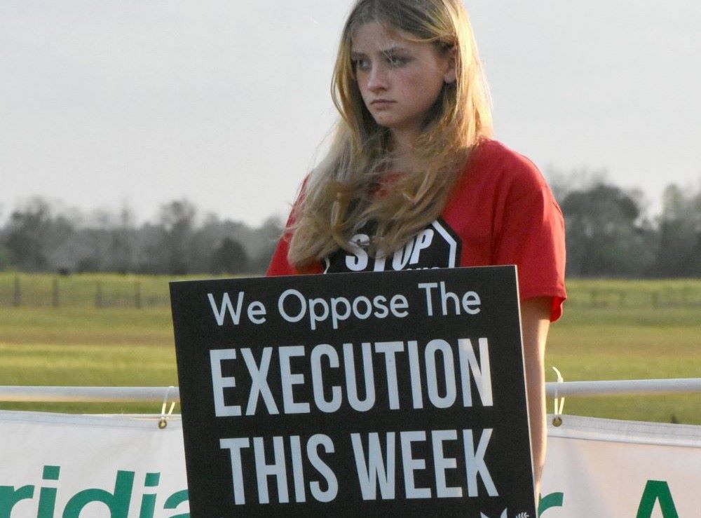 A student from Lourdes Academy Catholic School in Daytona Beach, Fla., protests the death penalty at the Florida State Prison Feb. 23, 2023. 